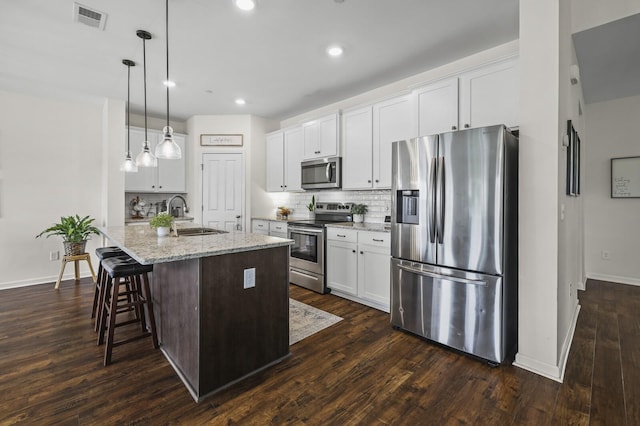 6013 Doster Rd, Smyrna, TN 37167 - kitchen with stainless steel appliances, a sink, tasteful backsplash, white cabinets, and an island with sink