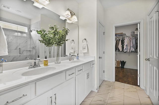 6013 Doster Rd, Smyrna, TN 37167 - bathroom featuring marble look tile flooring, double vanity, a shower stall, and a spacious closet