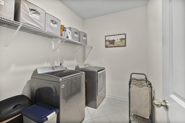 6013 Doster Rd, Smyrna, TN 37167 - washroom featuring washer and clothes dryer, light tile patterned flooring, and baseboards