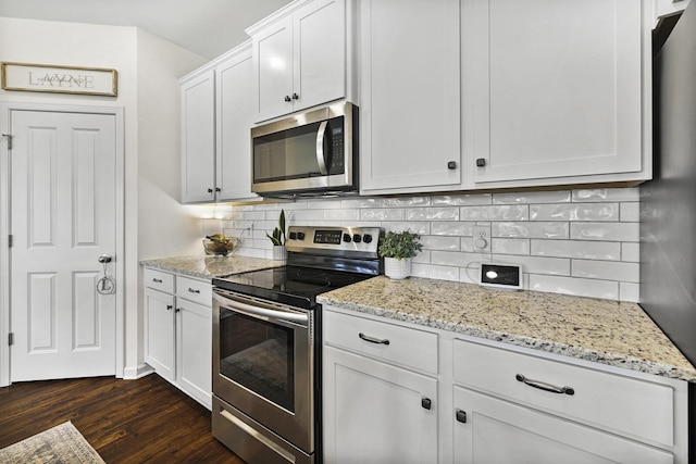6013 Doster Rd, Smyrna, TN 37167 - kitchen featuring stainless steel appliances, dark wood finished floors, light stone countertops, backsplash, and white cabinetry