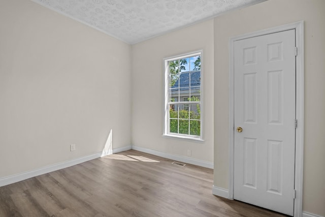 1601 S Willow St, Chattanooga, TN 37404 - spare room featuring wood finished floors, a textured ceiling, and baseboards