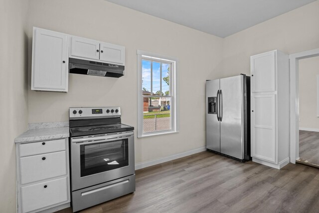 1601 S Willow St, Chattanooga, TN 37404 - kitchen featuring stainless steel appliances, under cabinet range hood, wood finished floors, and white cabinets