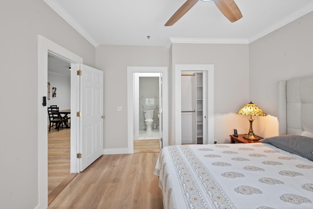 116 31st Ave N Unit 104, Nashville, TN 37203 - bedroom featuring light wood-style floors, crown molding, a walk in closet, ensuite bathroom, and a closet