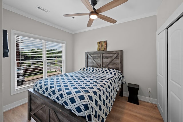 116 31st Ave N Unit 104, Nashville, TN 37203 - bedroom with crown molding, wood finished floors, a closet, and ceiling fan