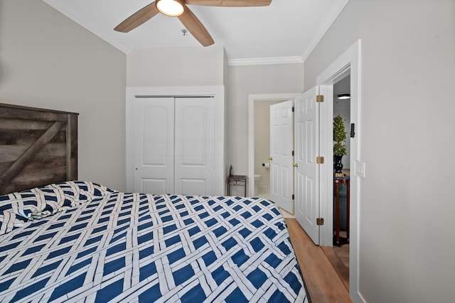 116 31st Ave N Unit 104, Nashville, TN 37203 - bedroom featuring ornamental molding, a closet, wood finished floors, and ceiling fan