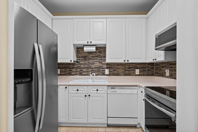116 31st Ave N Unit 104, Nashville, TN 37203 - kitchen featuring appliances with stainless steel finishes, light countertops, and white cabinets