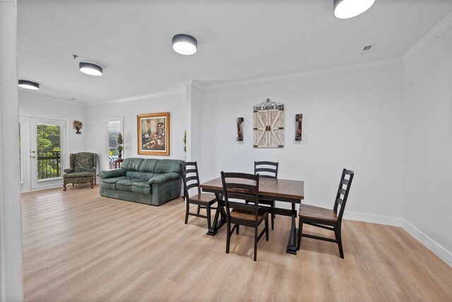 116 31st Ave N Unit 104, Nashville, TN 37203 - dining space with ornamental molding and light wood-style floors