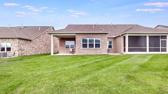 1137 Fiona Dr, Lebanon, TN 37087 - rear view of house featuring brick siding, a patio area, a sunroom, a yard, and roof with shingles