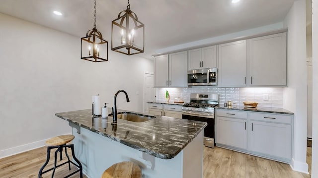 1137 Fiona Dr, Lebanon, TN 37087 - kitchen featuring stainless steel appliances, a sink, light wood-style floors, decorative backsplash, and recessed lighting