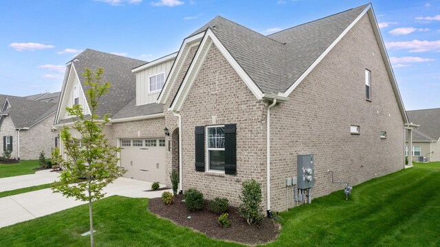 1137 Fiona Dr, Lebanon, TN 37087 - view of property exterior with brick siding, driveway, a lawn, a garage, and roof with shingles