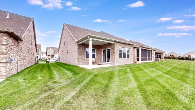 1137 Fiona Dr, Lebanon, TN 37087 - back of property with brick siding, a lawn, a sunroom, and a patio area