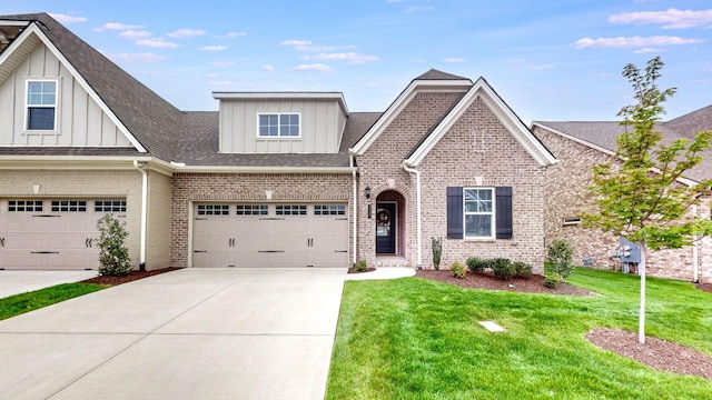 1137 Fiona Dr, Lebanon, TN 37087 - view of front facade with board and batten siding, brick siding, driveway, a front lawn, and a shingled roof