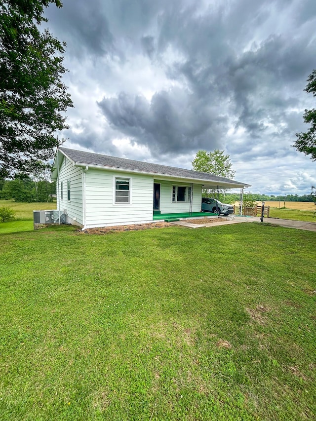 72 Allen Ln, Huntingdon, TN 38344 - view of front of home with a carport, driveway, a front lawn, and central air condition unit