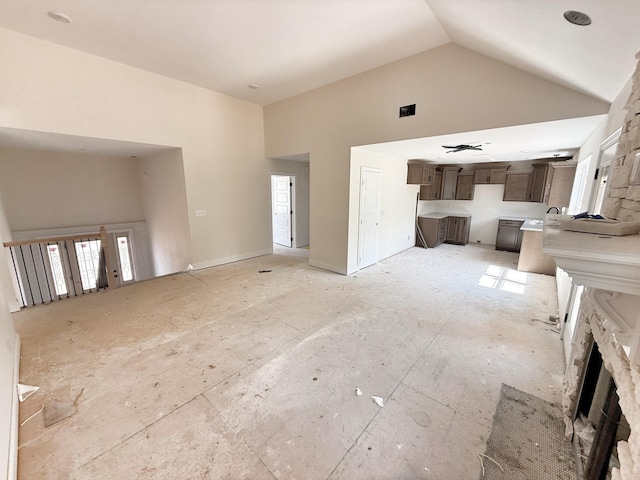 209 Griffey Ests, Clarksville, TN 37042 - unfurnished living room with high vaulted ceiling and a fireplace