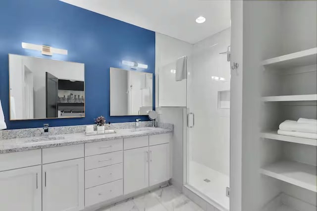 1144 Harmony Way, Nashville, TN 37207 - bathroom featuring a stall shower, double vanity, marble look tile flooring, and built in shelves