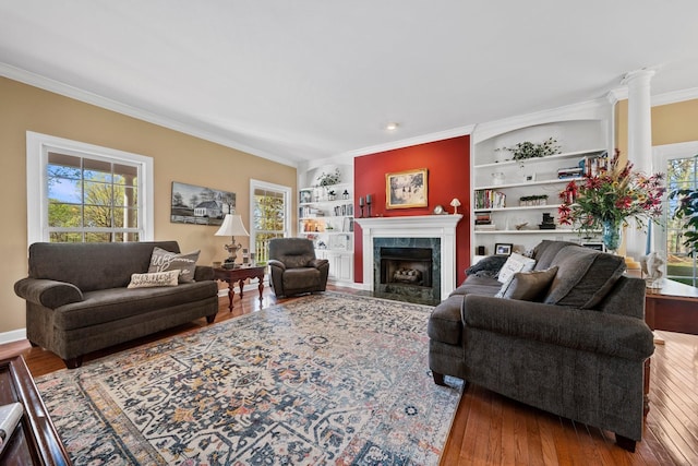266 Campground Rd, Olmstead, KY 42265 - living room featuring crown molding, built in features, wood finished floors, ornate columns, and a tiled fireplace