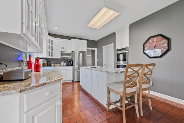 266 Campground Rd, Olmstead, KY 42265 - kitchen with stainless steel appliances, white cabinetry, brick patterned flooring, recessed lighting, and glass insert cabinets