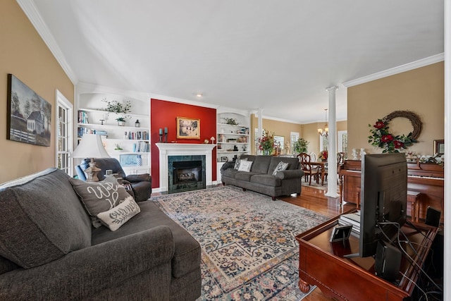 266 Campground Rd, Olmstead, KY 42265 - living area featuring ornate columns, built in shelves, ornamental molding, wood finished floors, and a high end fireplace