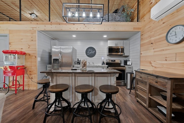 266 Campground Rd, Olmstead, KY 42265 - kitchen featuring stainless steel appliances, wooden walls, a wall unit AC, dark wood-style floors, and a kitchen island