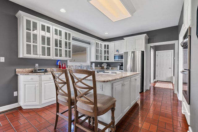 266 Campground Rd, Olmstead, KY 42265 - kitchen with appliances with stainless steel finishes, brick floors, white cabinetry, and recessed lighting
