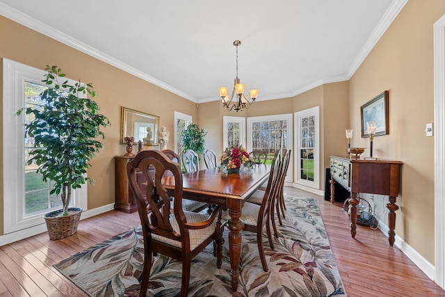 266 Campground Rd, Olmstead, KY 42265 - dining space featuring healthy amount of natural light, a chandelier, wood finished floors, ornamental molding, and baseboards