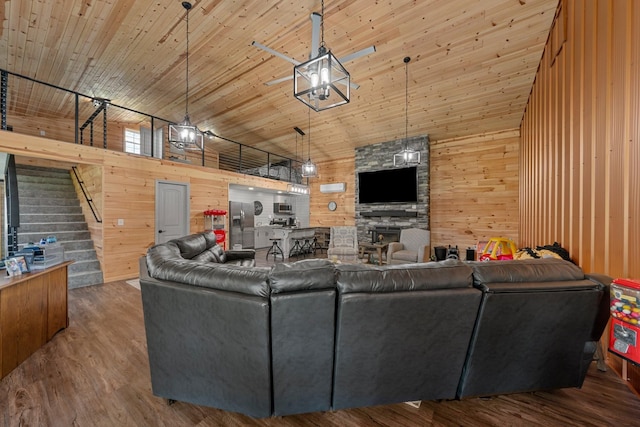 266 Campground Rd, Olmstead, KY 42265 - living area with wood walls, stairs, a stone fireplace, wood finished floors, and high vaulted ceiling