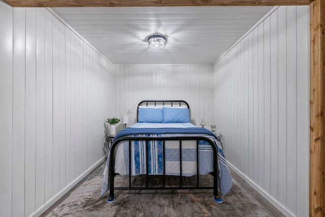266 Campground Rd, Olmstead, KY 42265 - bedroom featuring baseboards, concrete floors, and wooden walls