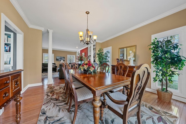 266 Campground Rd, Olmstead, KY 42265 - dining space with light wood-style flooring, decorative columns, a chandelier, crown molding, and baseboards