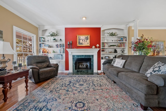 266 Campground Rd, Olmstead, KY 42265 - living area featuring crown molding, built in shelves, wood finished floors, and a tiled fireplace