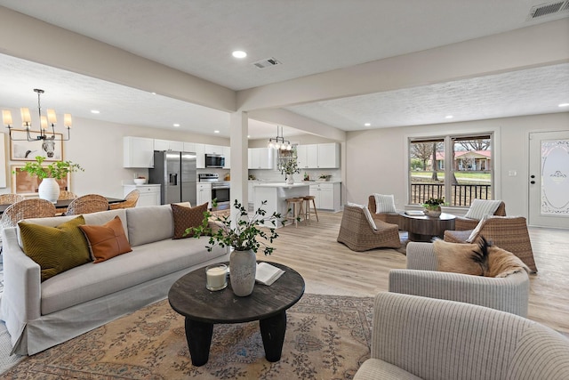 151 John D St, La Vergne, TN 37086 - living room featuring a chandelier, light wood-style floors, and recessed lighting
