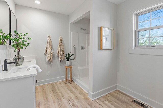 151 John D St, La Vergne, TN 37086 - full bathroom featuring double vanity, wood finished floors, a shower, and recessed lighting