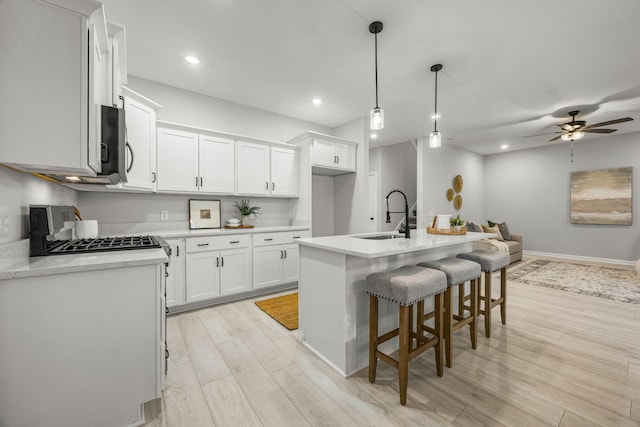 264 Kildeer Dr, Clarksville, TN 37040 - kitchen with a sink, light wood-style flooring, a ceiling fan, white cabinetry, and recessed lighting
