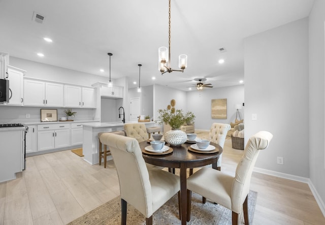 264 Kildeer Dr, Clarksville, TN 37040 - dining area with recessed lighting, ceiling fan, baseboards, light wood-style flooring, and a chandelier