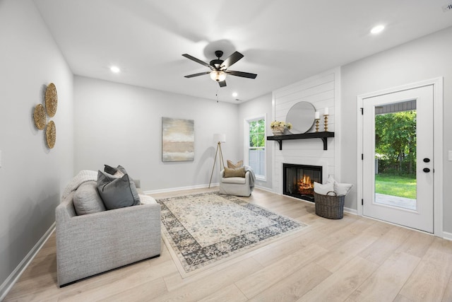 264 Kildeer Dr, Clarksville, TN 37040 - living area with a large fireplace, wood finished floors, a ceiling fan, recessed lighting, and baseboards