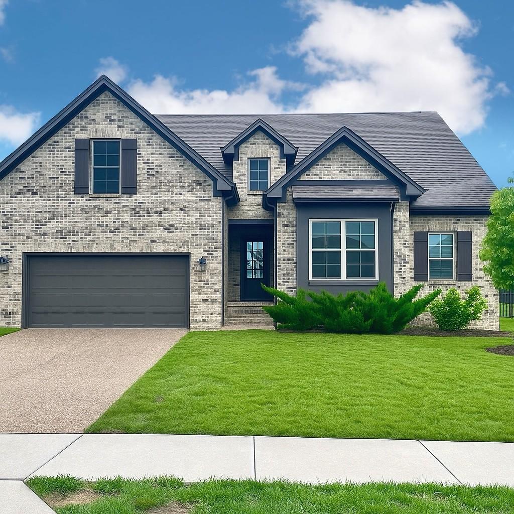 1712 Sorrell Park Dr, Spring Hill, TN 37174 - view of front of home featuring a garage, a front lawn, driveway, brick siding, and a shingled roof