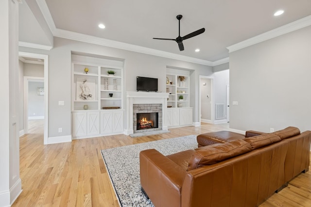 1712 Sorrell Park Dr, Spring Hill, TN 37174 - living area with a ceiling fan, a fireplace, light wood-style flooring, baseboards, and crown molding
