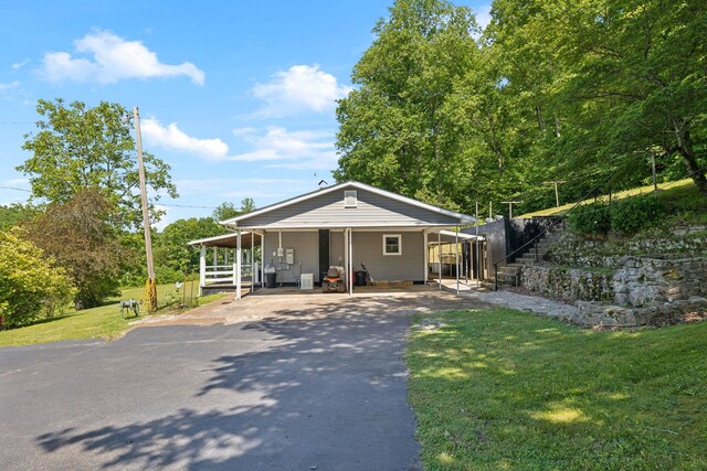 1540 Centerville Hwy, Hohenwald, TN 38462 - view of front of house featuring asphalt driveway, a front lawn, and a carport