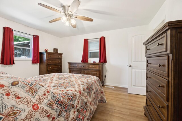 1540 Centerville Hwy, Hohenwald, TN 38462 - bedroom featuring light wood-type flooring, baseboards, a ceiling fan, and cooling unit