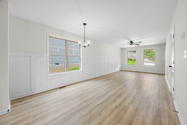 174 Oak St, Clarksville, TN 37042 - unfurnished room with a chandelier, light wood-style flooring, a decorative wall, a ceiling fan, and a wainscoted wall