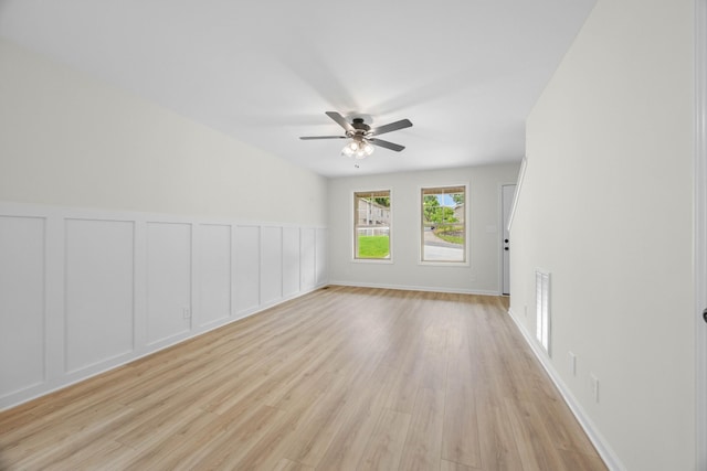 174 Oak St, Clarksville, TN 37042 - spare room featuring a ceiling fan, light wood-style floors, a decorative wall, and a wainscoted wall