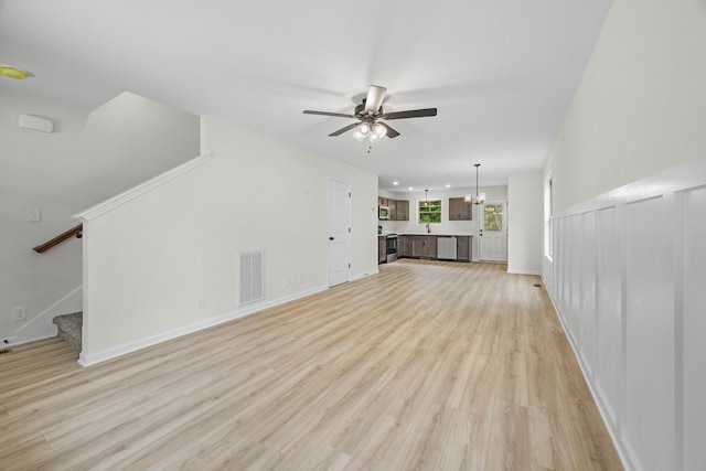 174 Oak St, Clarksville, TN 37042 - unfurnished living room featuring ceiling fan, light wood-type flooring, stairway, and baseboards