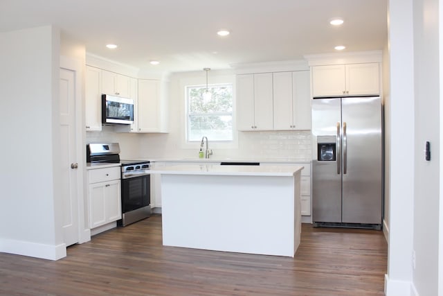 2513 Hickory Dr, Springfield, TN 37172 - kitchen featuring stainless steel appliances, dark wood-style floors, tasteful backsplash, white cabinetry, and recessed lighting