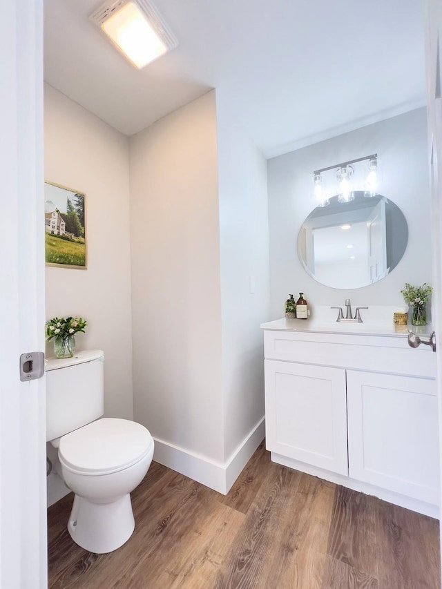 2513 Hickory Dr, Springfield, TN 37172 - half bathroom featuring toilet, vanity, wood finished floors, and baseboards