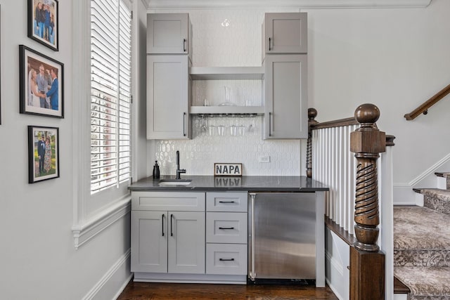 100 Church St, Franklin, TN 37064 - indoor wet bar featuring stainless steel fridge, stairway, dark wood-type flooring, decorative backsplash, and baseboards