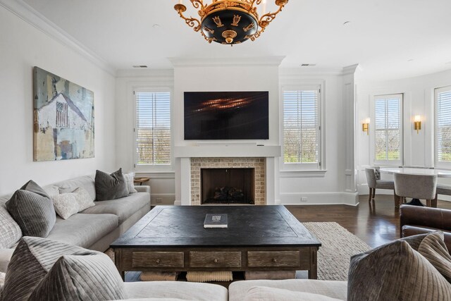 100 Church St, Franklin, TN 37064 - living area with a fireplace, crown molding, healthy amount of natural light, wood finished floors, and baseboards