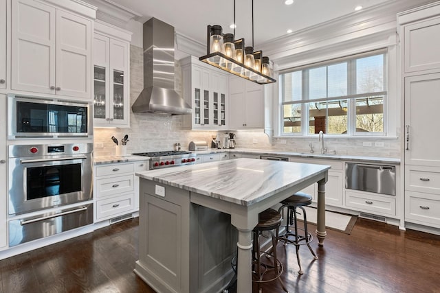 100 Church St, Franklin, TN 37064 - kitchen featuring stainless steel appliances, a warming drawer, wall chimney range hood, a sink, and dark wood finished floors