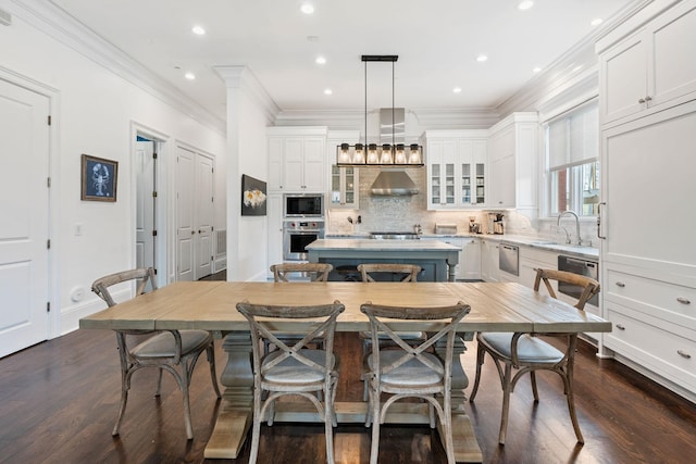 100 Church St, Franklin, TN 37064 - kitchen featuring stainless steel appliances, a center island, wall chimney range hood, a sink, and white cabinets
