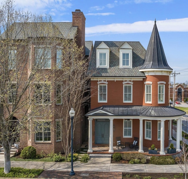 100 Church St, Franklin, TN 37064 - view of front of home featuring brick siding, a chimney, covered porch, and a high end roof