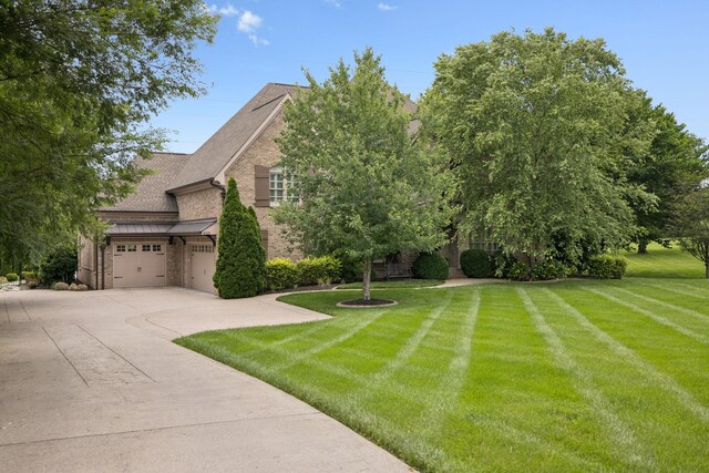 2433 Durham Manor Dr, Franklin, TN 37064 - view of front facade with a front yard, driveway, stone siding, brick siding, and a shingled roof