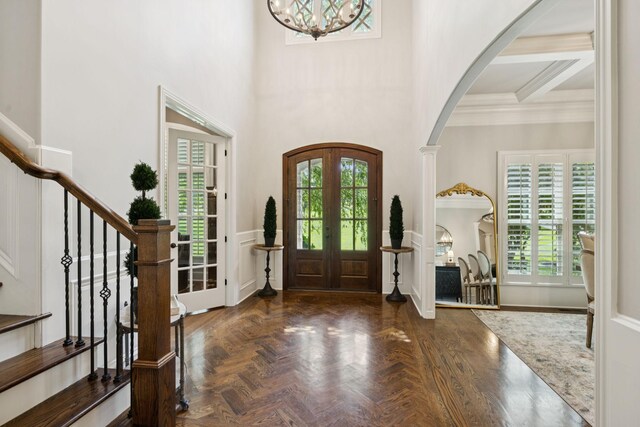 2433 Durham Manor Dr, Franklin, TN 37064 - entrance foyer with arched walkways, stairway, a chandelier, french doors, and ornamental molding